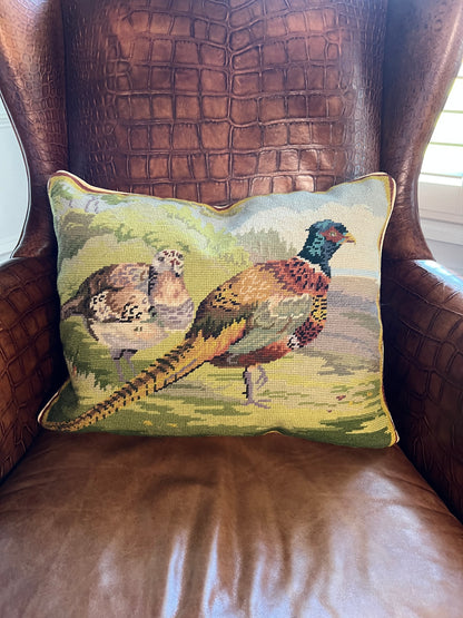 16x20 needlepoint pillow with pheasant and grouse on a brown leather wingback chair.