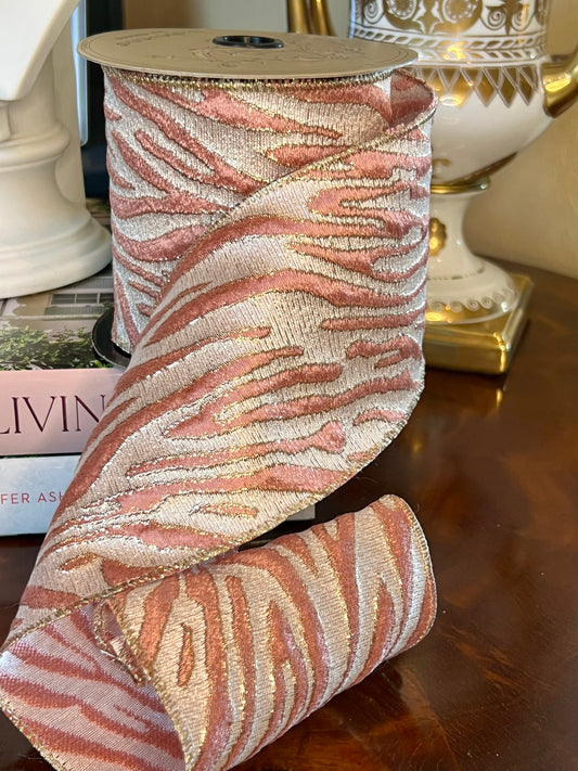Rose pink and champagne gold animal stripe wired ribbon on spool.