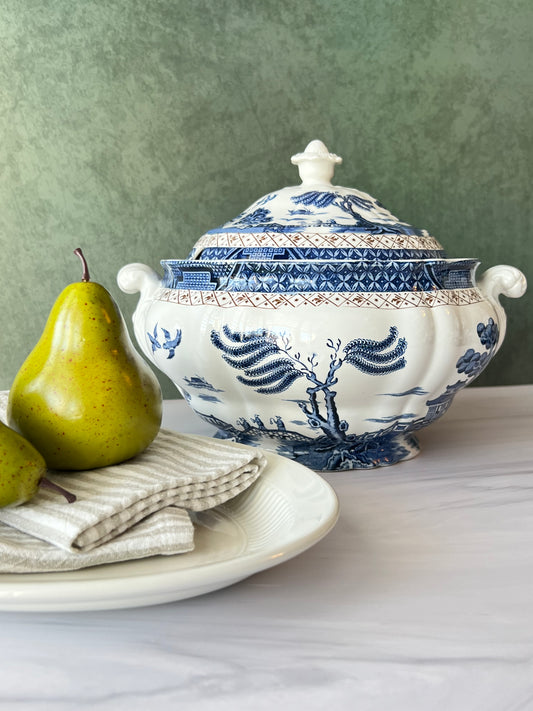 Vintage Booths Real Old Willow blue and white tureen with lid, styled with pears on marble background.
