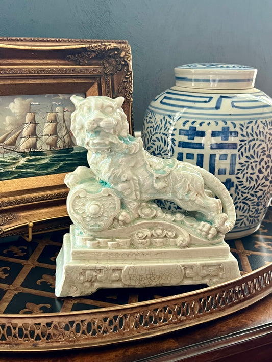 Celadon tiger guardian figurine with crackle glaze and ornate sculpted details.