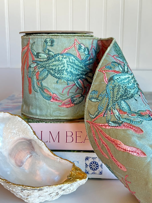 Celadon green embroidered crab and coral wired ribbon on spool.