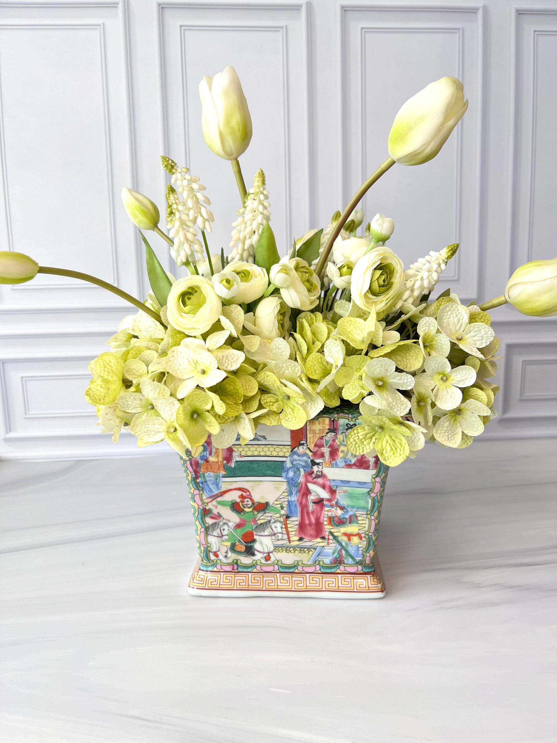 Square rose medallion porcelain planter in pink, green, blue, and yellow, styled with a lush floral arrangement for display.