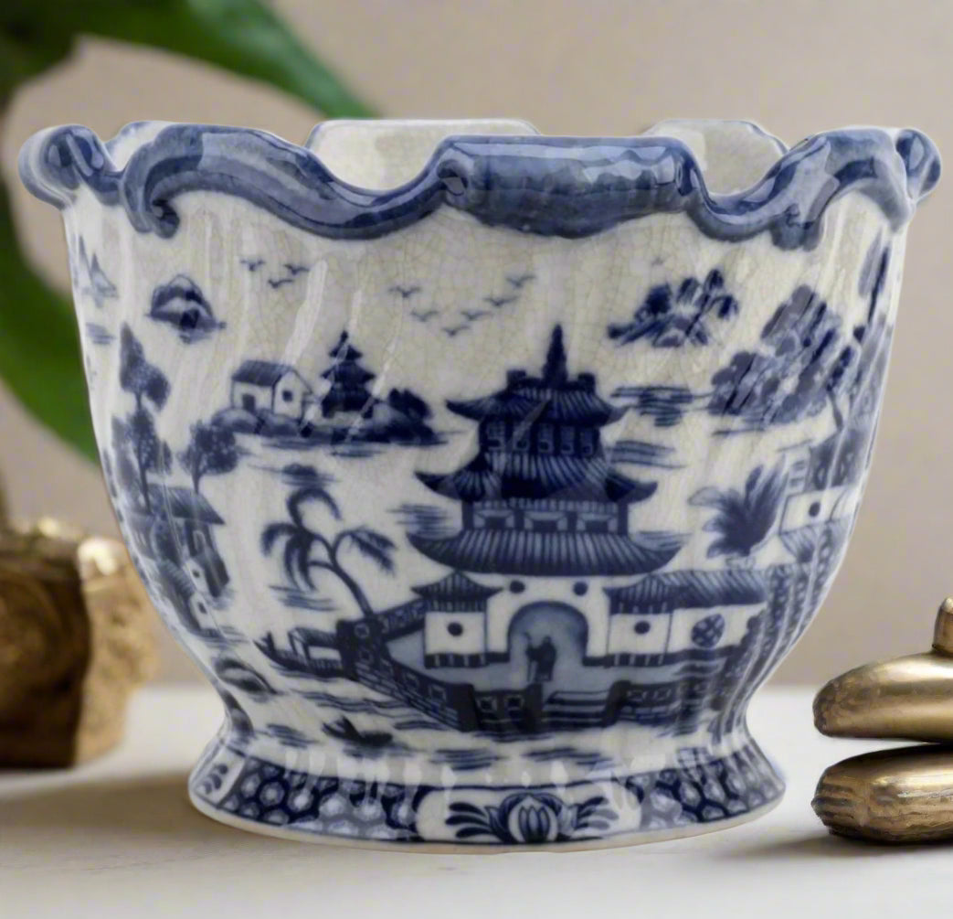 Blue Willow scalloped porcelain planter with pagoda landscape pattern styled on a white tabletop