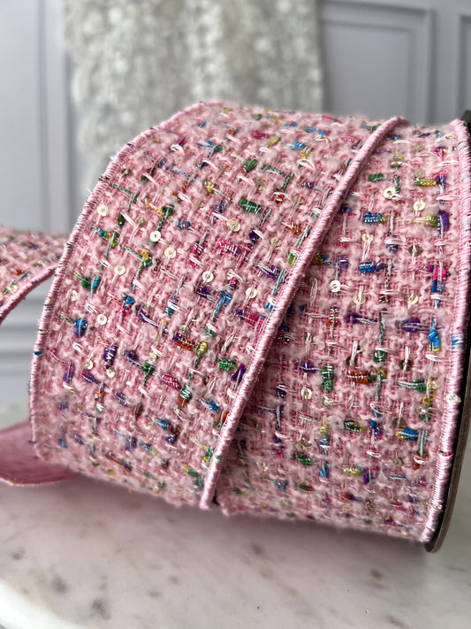 A textured blush bouclé ribbon with fine metallic threads and subtle sequins. Wired for shaping elegant bows and thoughtful finishing details.