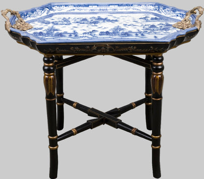 Blue willow tray table with black bamboo-style base and gold accents.