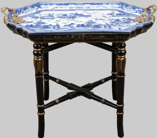 Blue willow tray table with black bamboo-style base and gold accents.