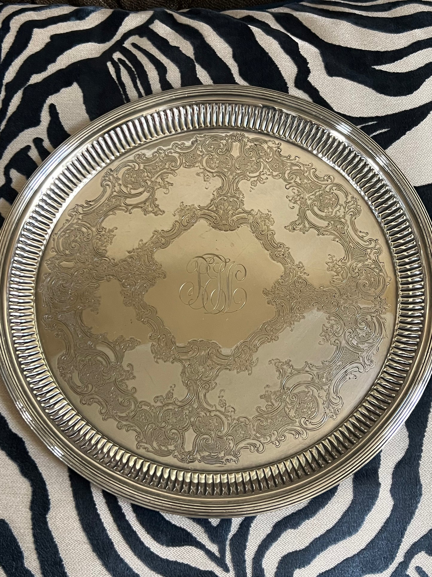 Gorham silver-plated round serving tray with ornate embossed floral design and center monogram