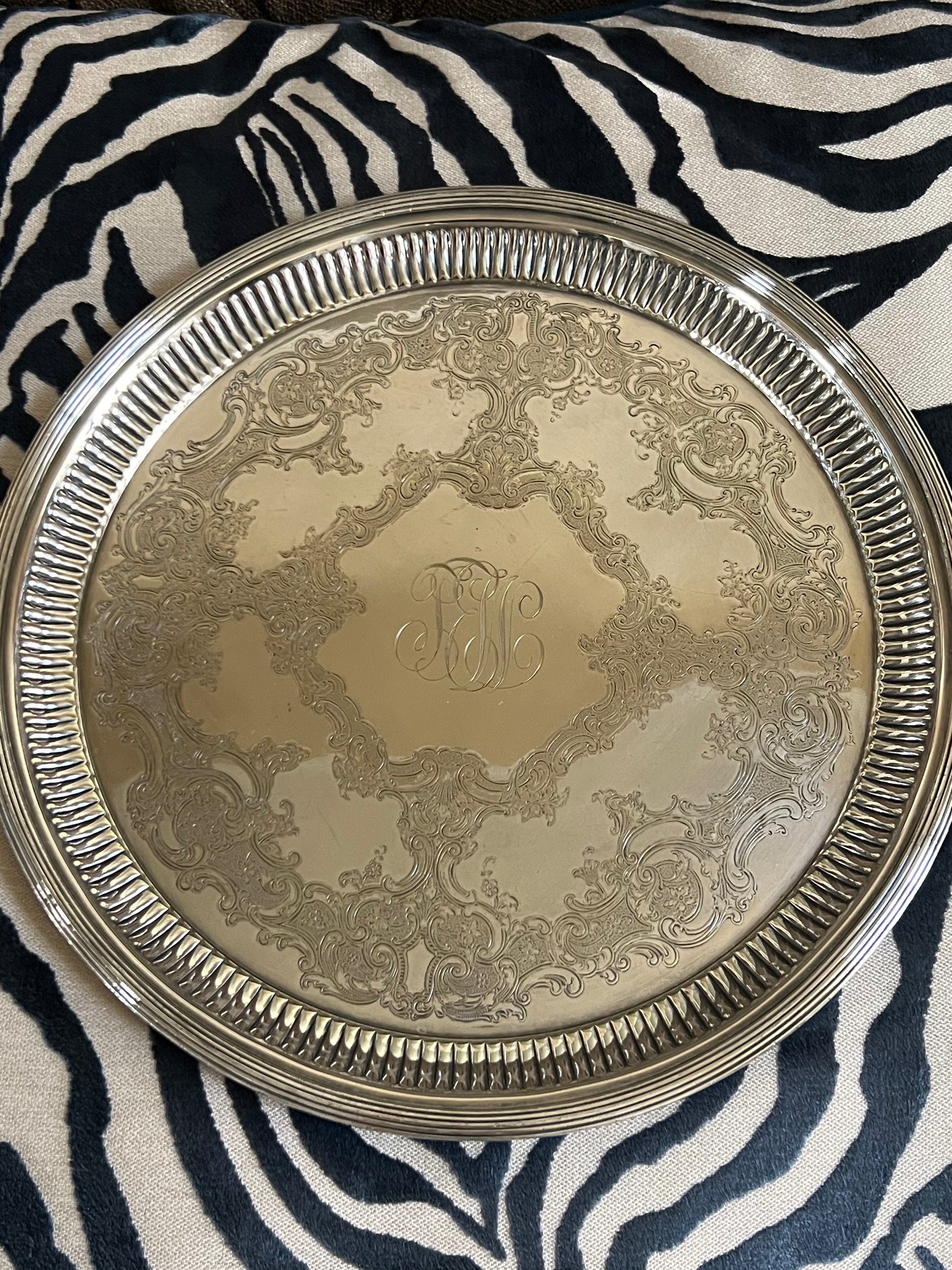 Gorham silver-plated round serving tray with ornate embossed floral design and center monogram