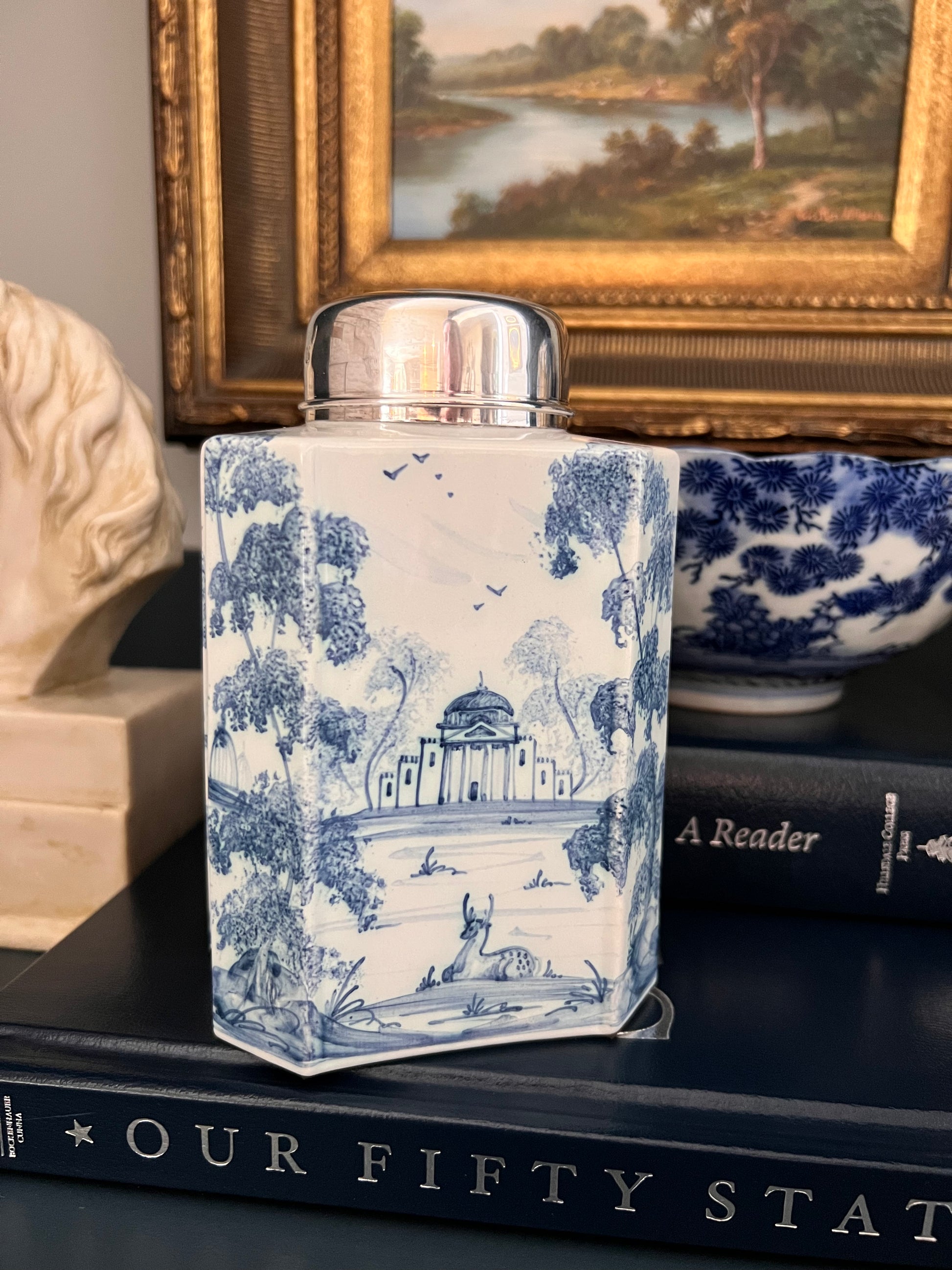 Hand-painted blue and white tea caddy by Deborah Sears Isis Ceramics with silver lid and pastoral landscape design