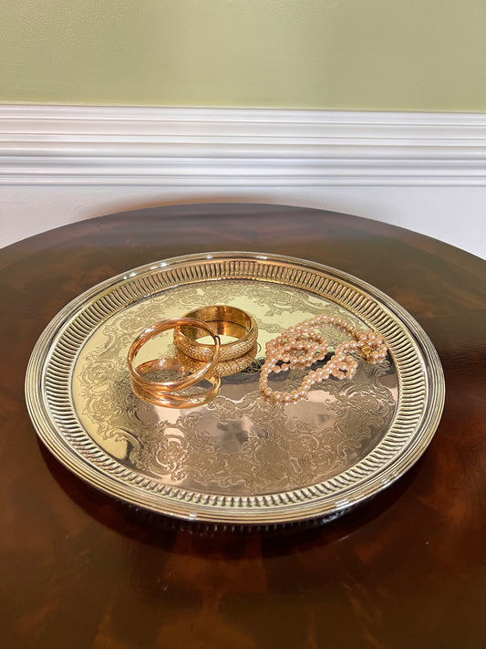 An ornate round silver-plated Gorham Superfine serving tray with a decorative embossed floral pattern and a monogram in the center.